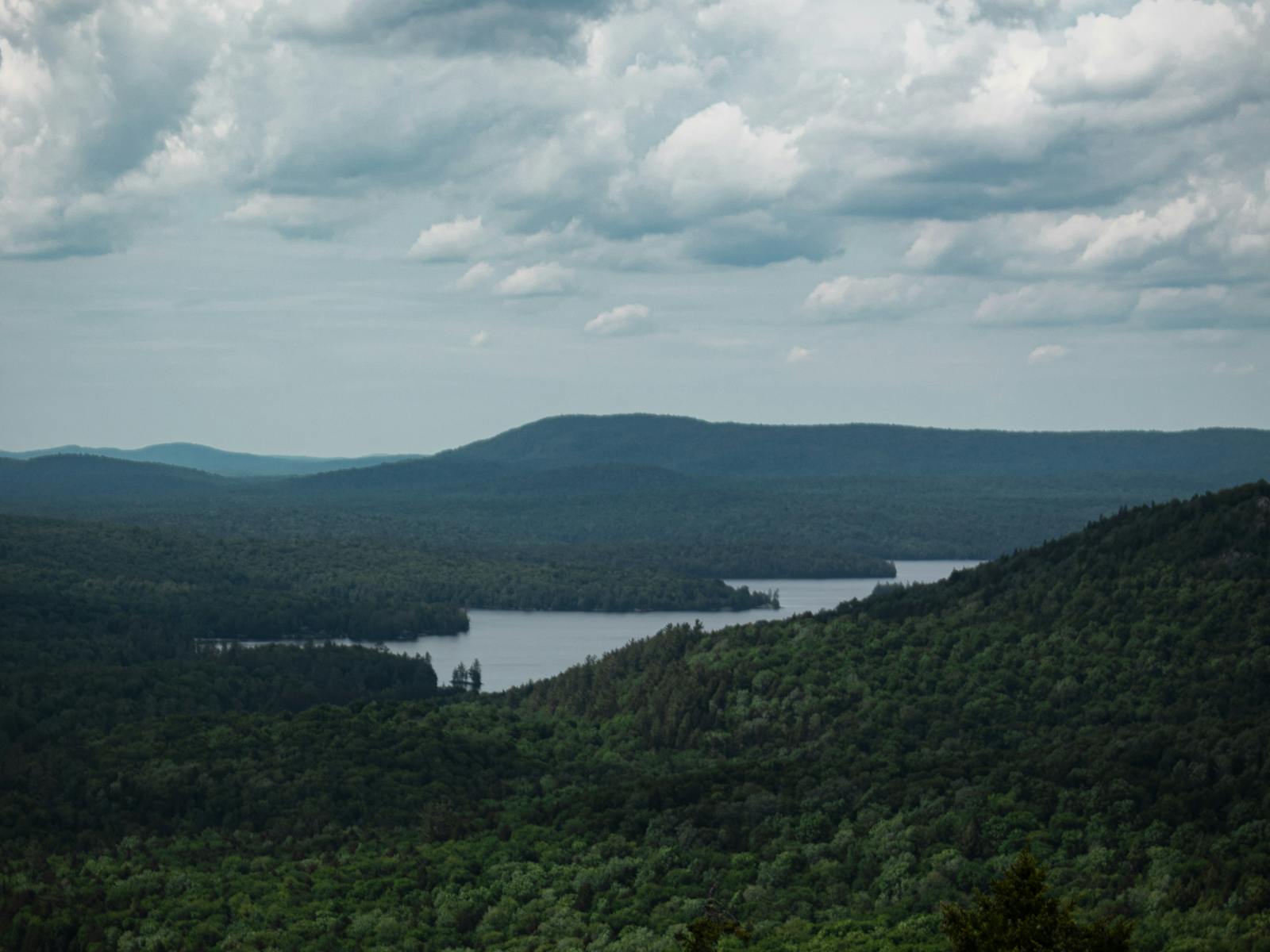 Adirondack lake and mountains under a cloudy sky