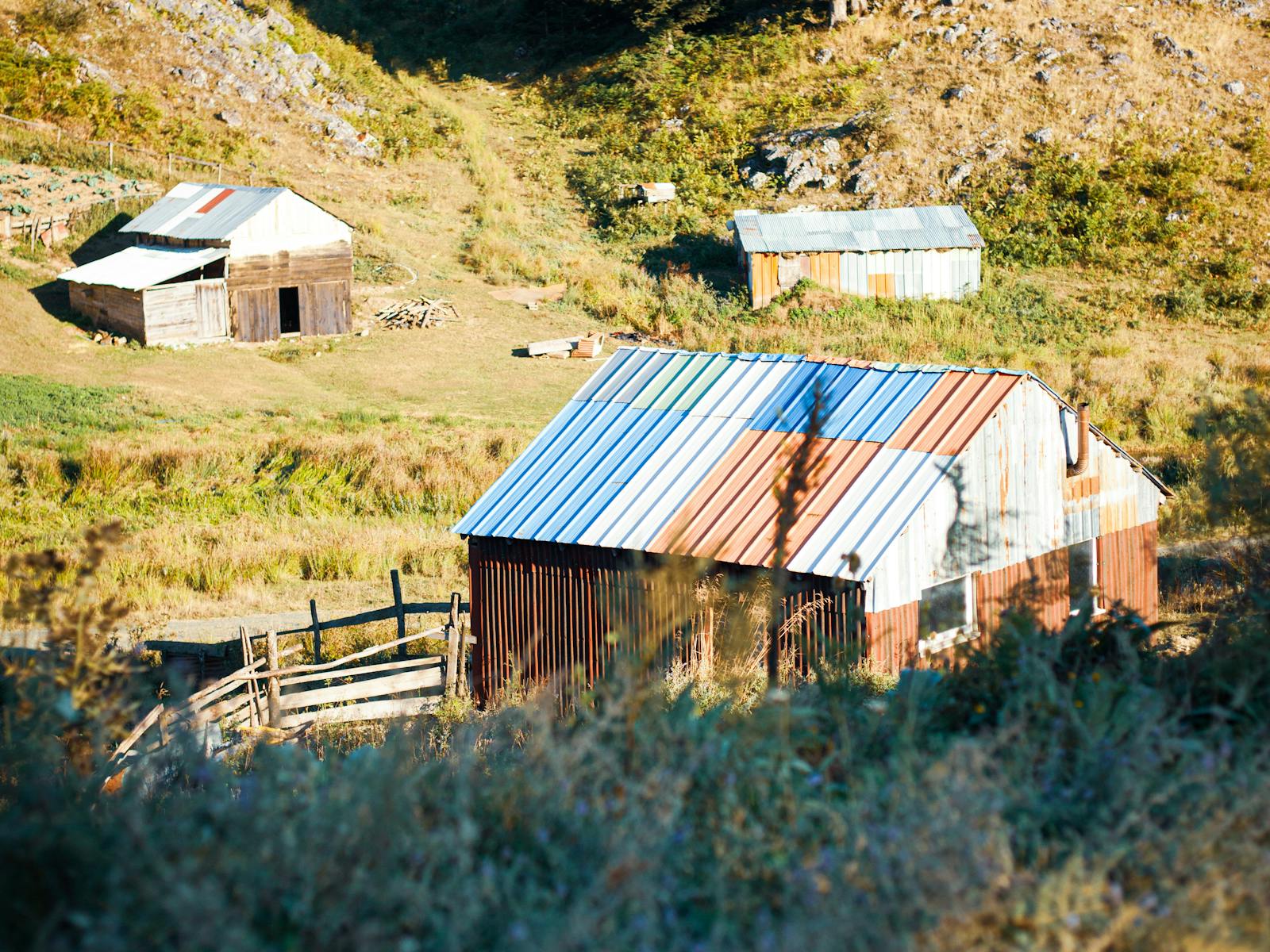 Rustic cabins in a green mountain valley